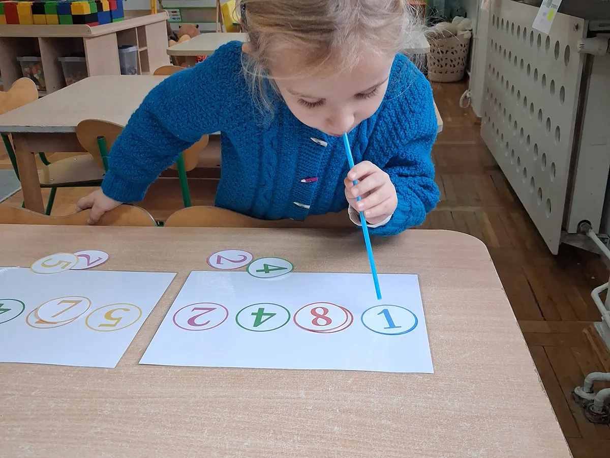  Dziecko siedzi przy stole