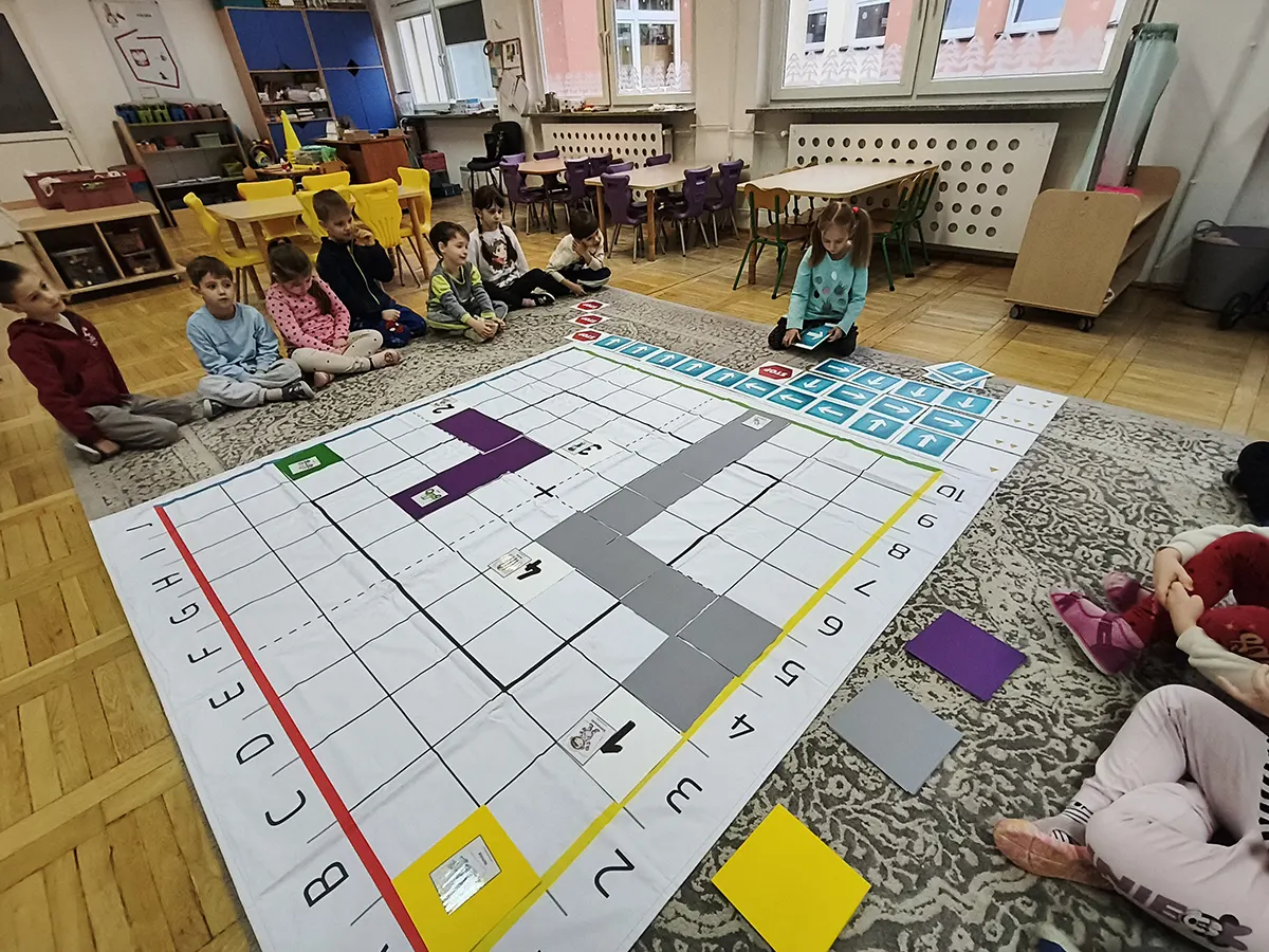  Dzieci siedzą przy macie